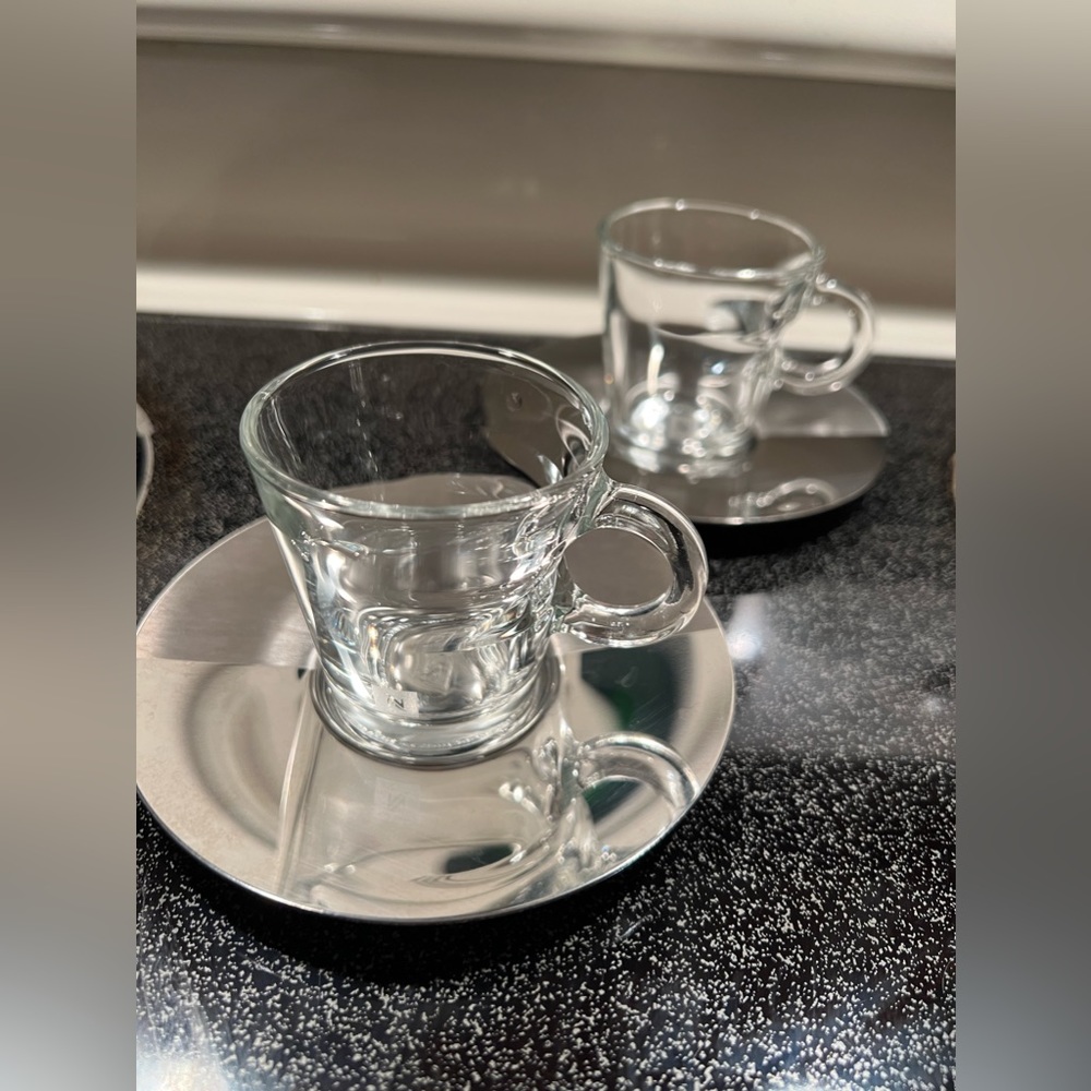 Nespresso cups and stainless steel saucers.